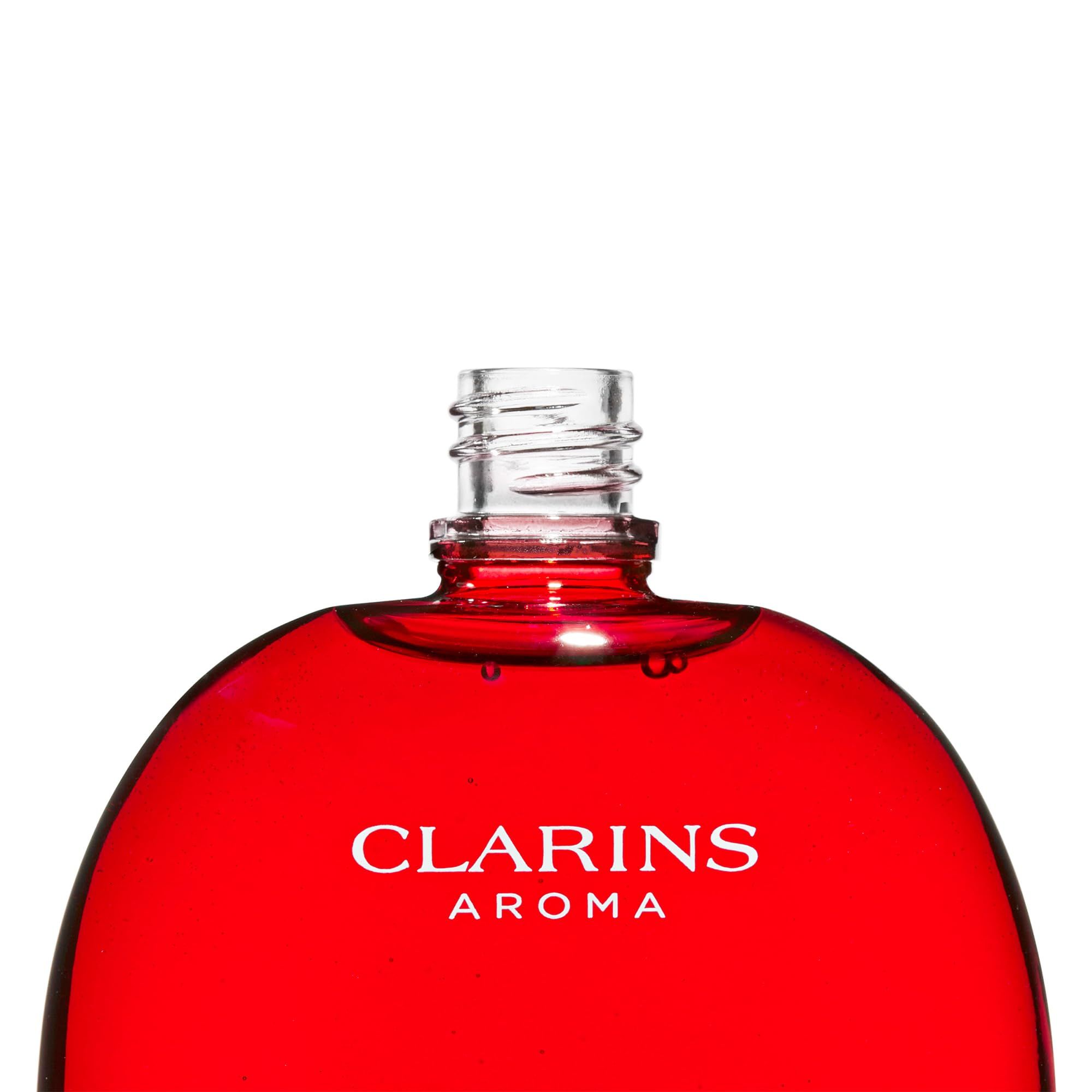 Rote Flasche ohne Verschluss. Aufschrift: Clarins Aroma.