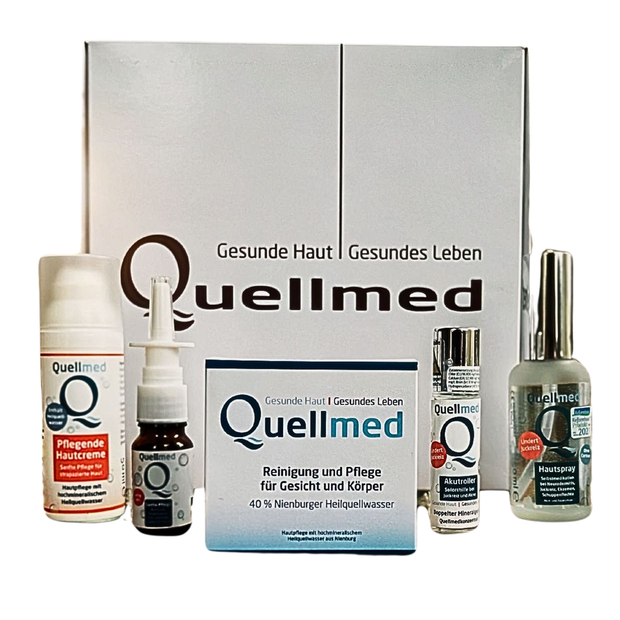 Mehrere Quellmed-Produkte, darunter Cremes und Sprays, in einer weißen Box. Aufschrift: Quellmed, Gesunde Haut, Gesundes Leben.