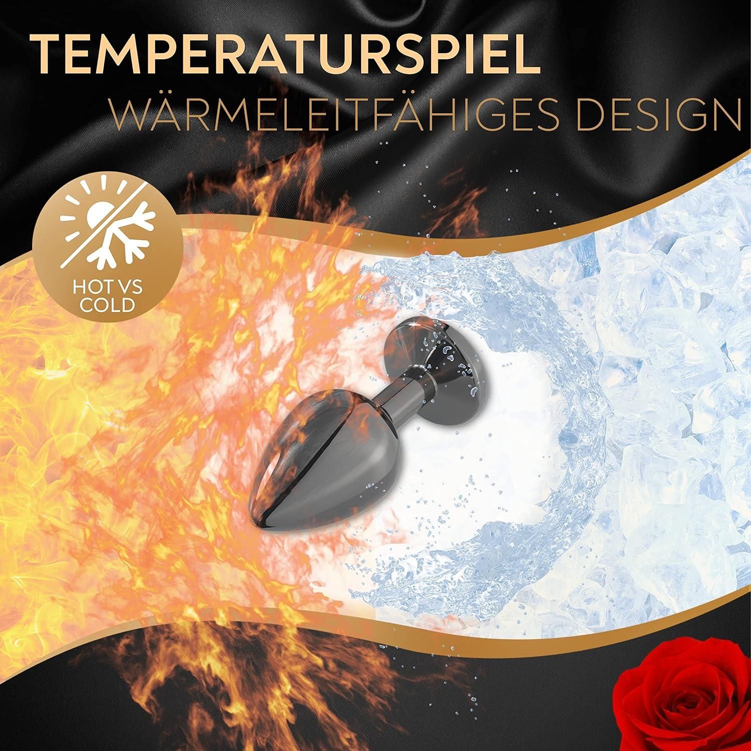 Analplug mit schwarzem Schaft und Edelstein-Aufsatz. Darstellung von Hitze und Kälte. Text: Temperaturspiel, wärmeleitfähiges Design.
