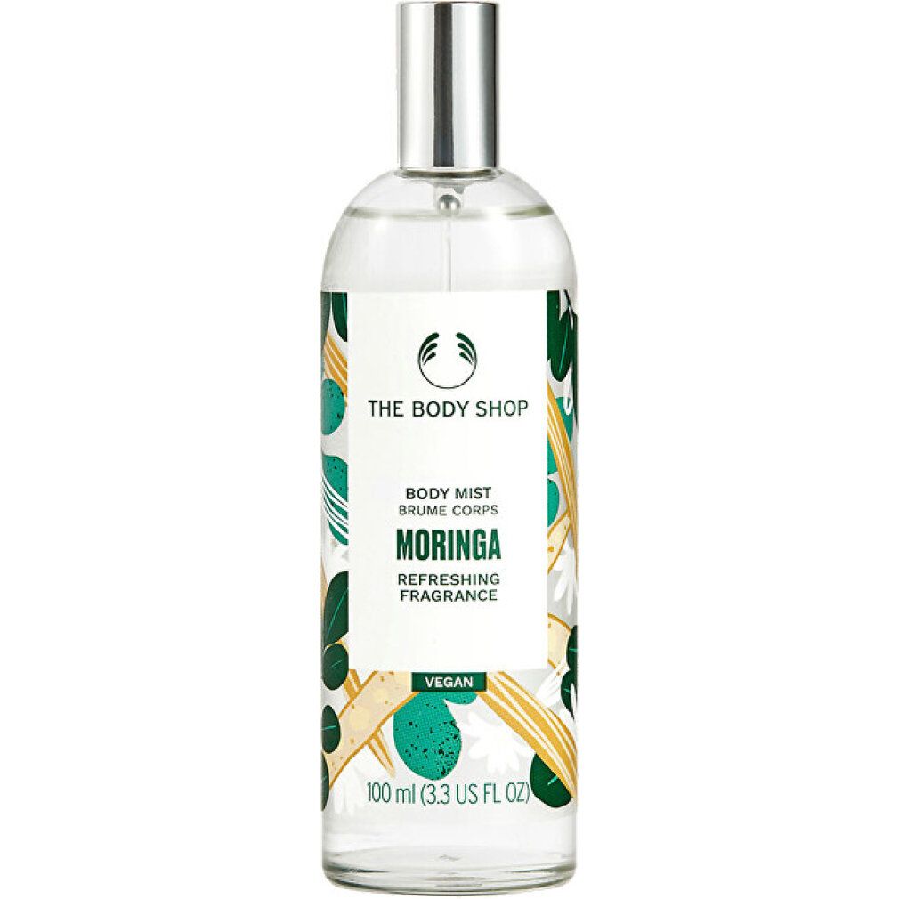 Körpernebel-Flasche mit Sprühkopf. Aufschrift: Moringa, The Body Shop. Grüne und gelbe Verzierungen.