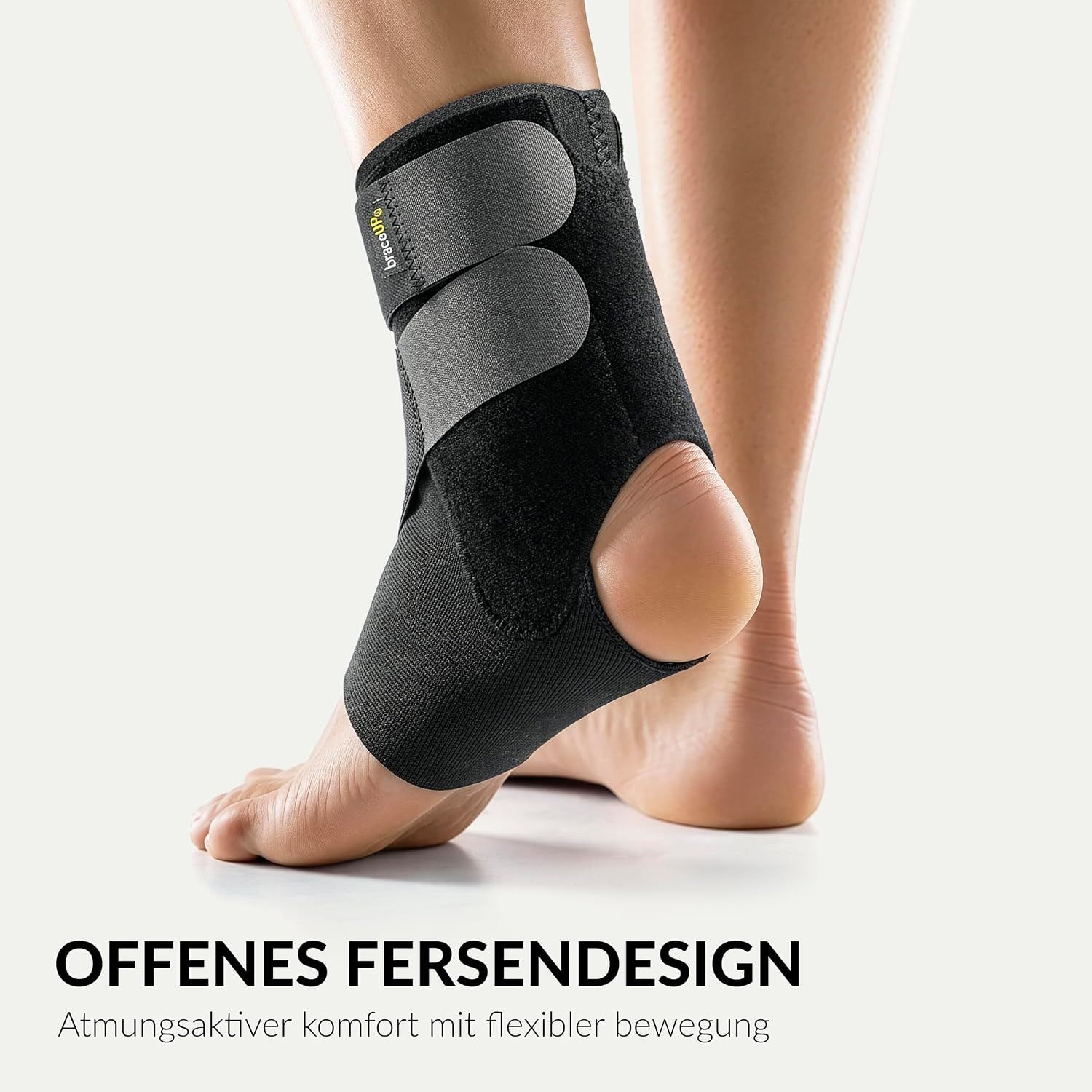 Schwarze Knöchelbandage mit offenem Fersendesign und Klettverschlüssen.