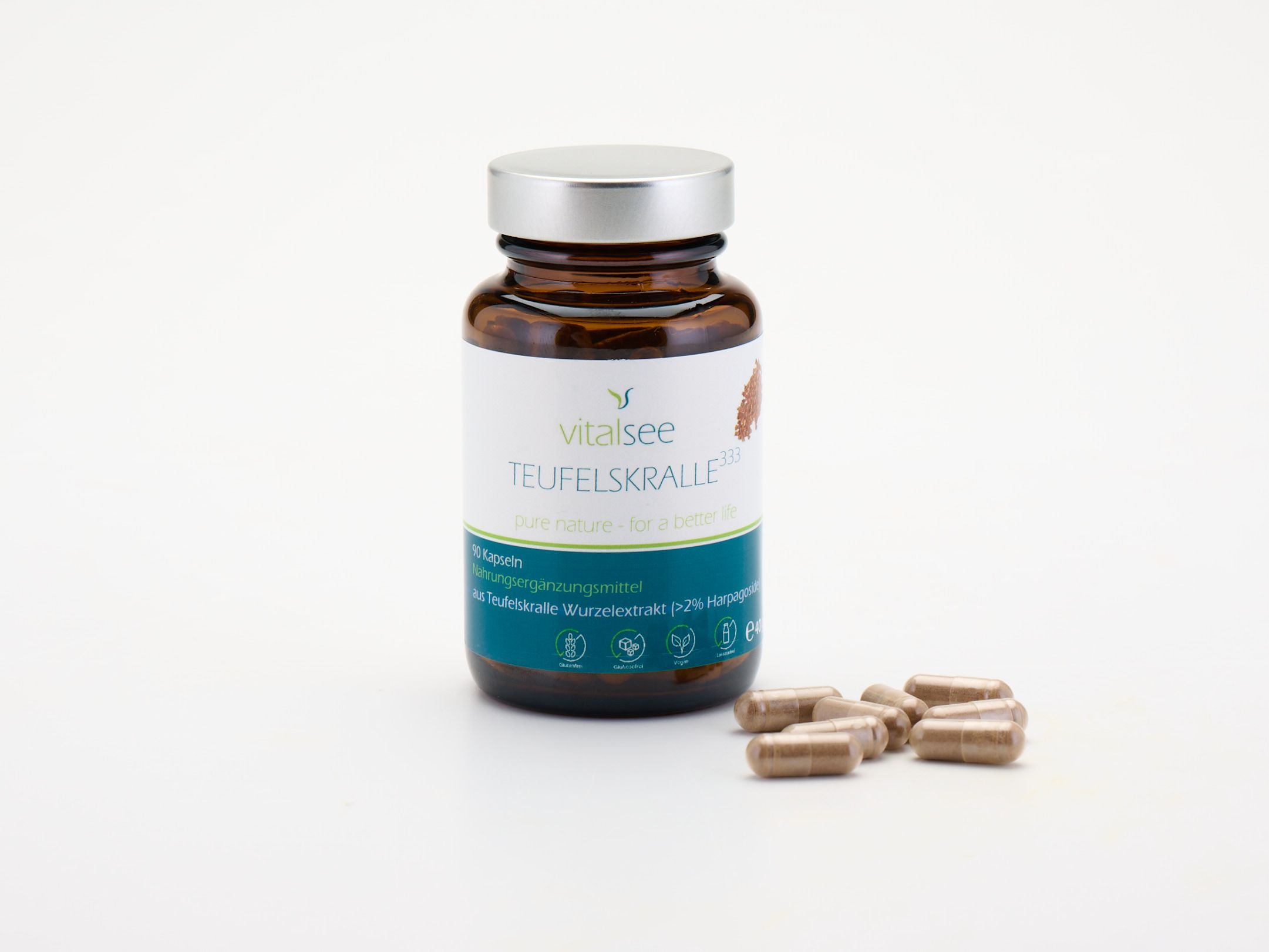 Braune Glasflasche mit silbernem Deckel und Kapseln daneben. Weißes Etikett mit Produktnamen.