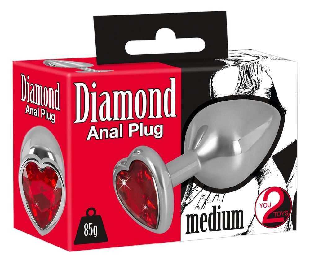 Verpackung mit Analplug. Aufschrift: Diamond Anal Plug medium. Herzförmiger, roter Schmuckstein.
