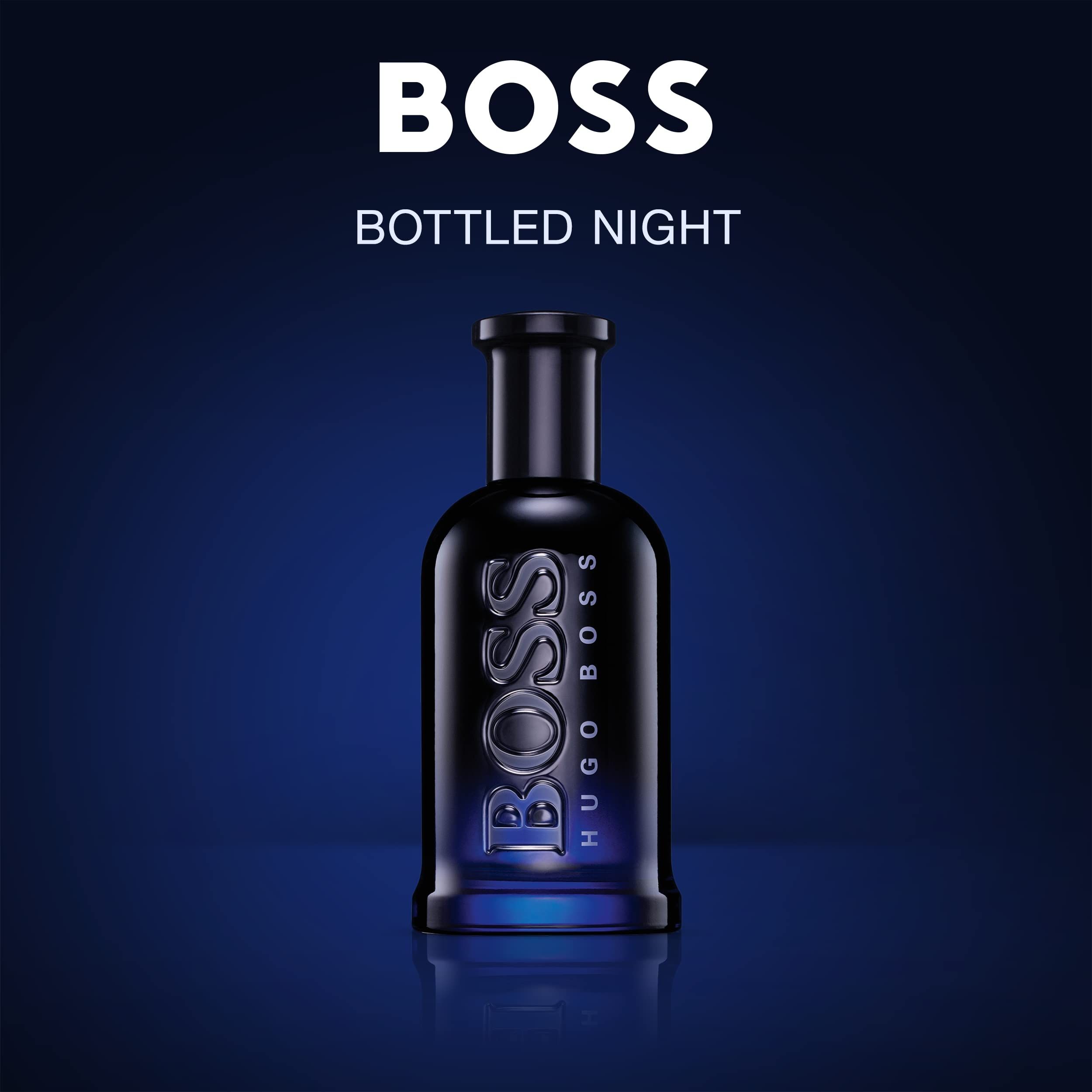 Dunkelblaue Glasflasche mit silbernem BOSS HUGO BOSS Schriftzug auf blauem Hintergrund.