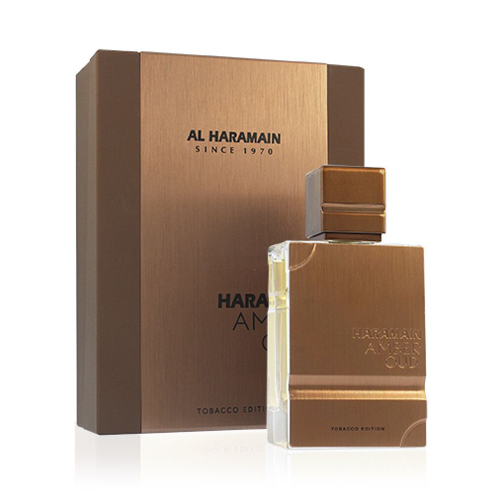 Parfümflasche und Verpackung. Aufschrift: Al Haramain, Amber Oud Tobacco Edition. Flasche und Box in Braun- und Goldtönen.