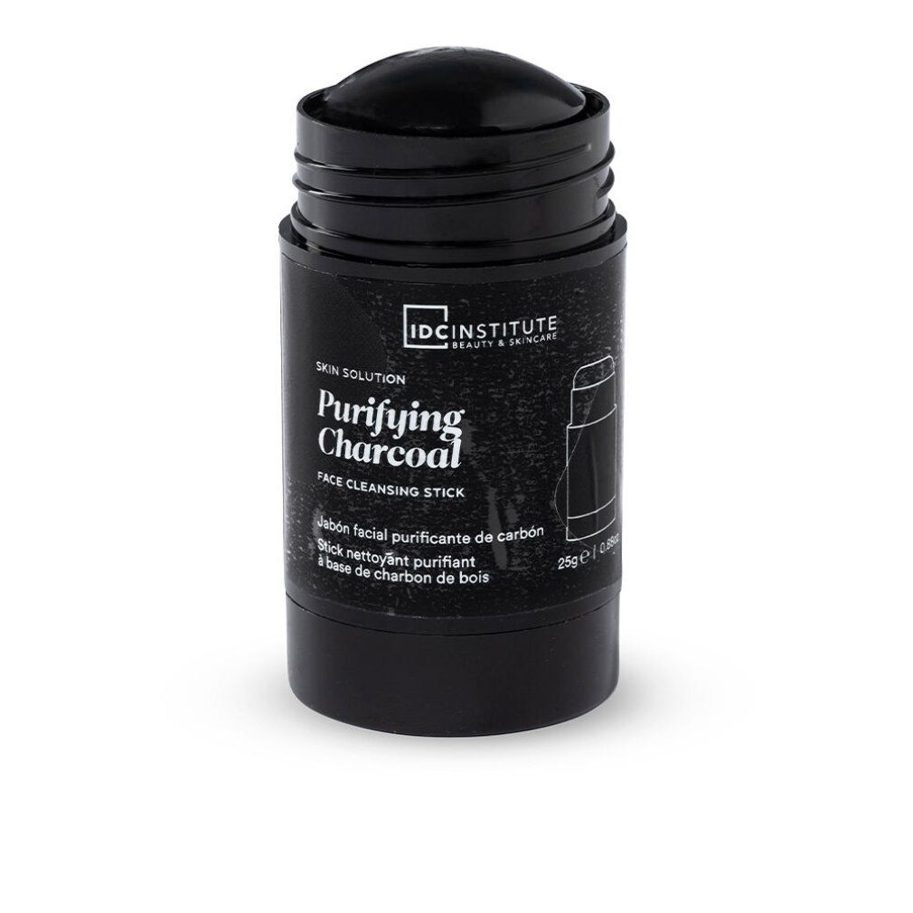 Schwarzer Reinigungsstick. Aufschrift: Purifying Charcoal, IDC INSTITUTE. Zylinderförmige Verpackung.