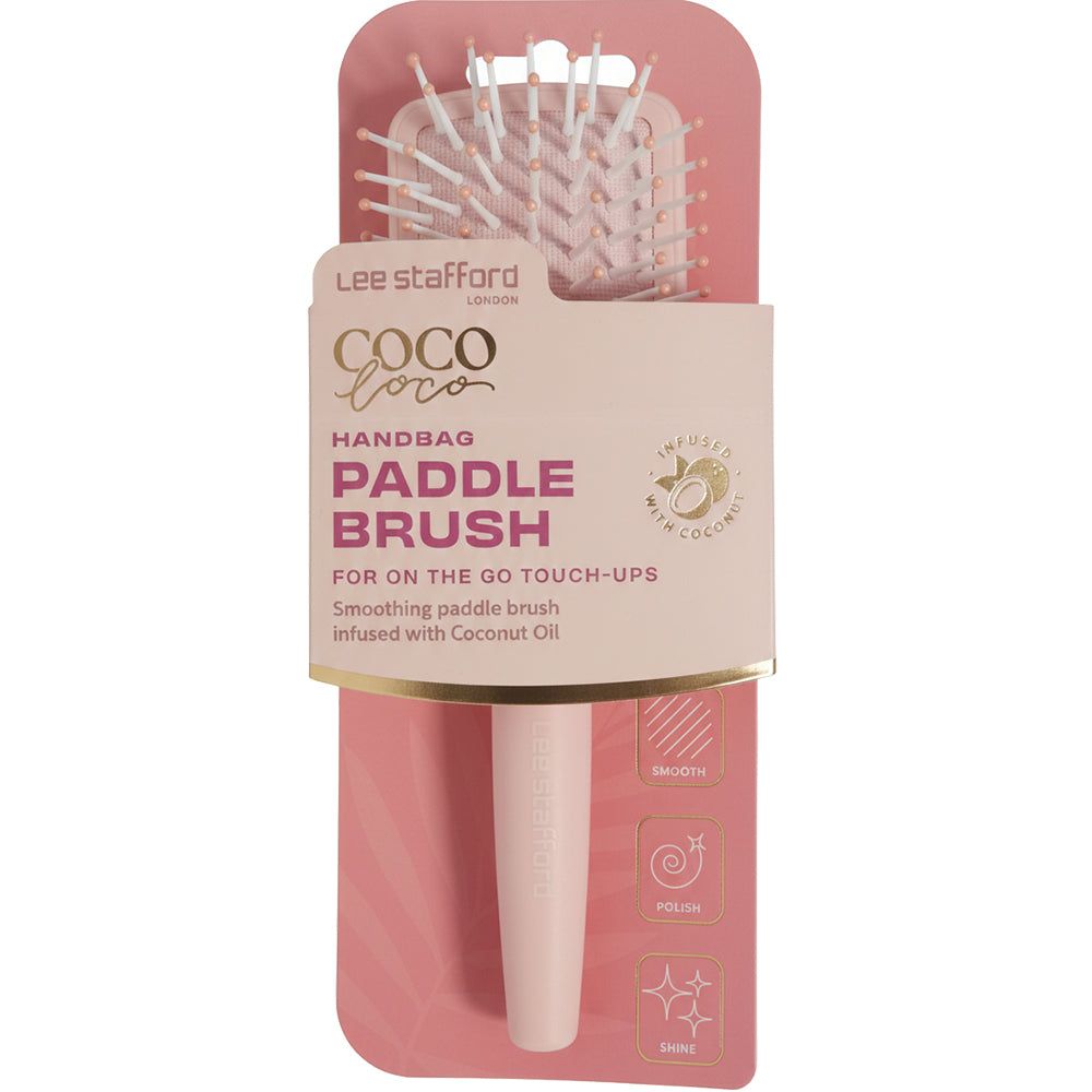 Eine hellrosa Haarbürste in Verpackung mit dem Produktnamen 'Coco Loco Handbag Paddle Brush'.