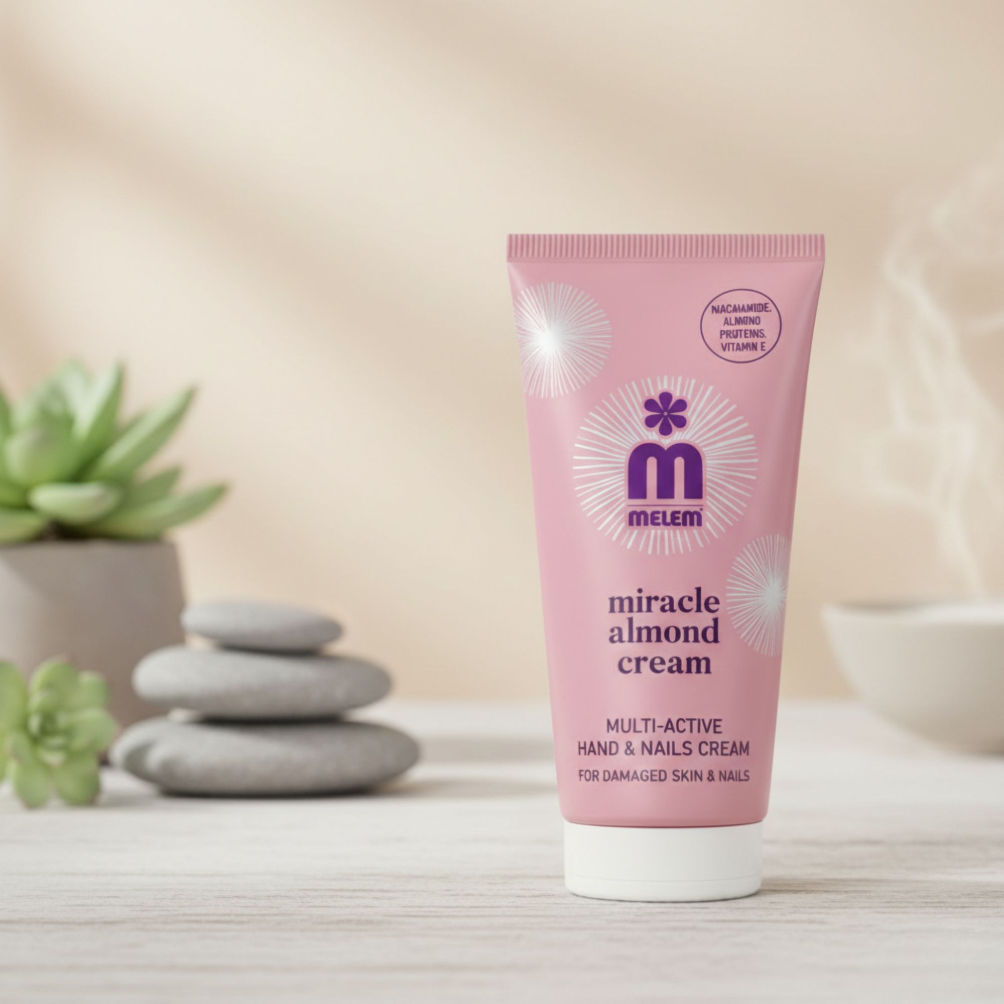 Rosa Tube mit "melem miracle almond cream". Text: Multi-Active Hand & Nails Cream. Für geschädigte Haut & Nägel. Mit Mandelöl.