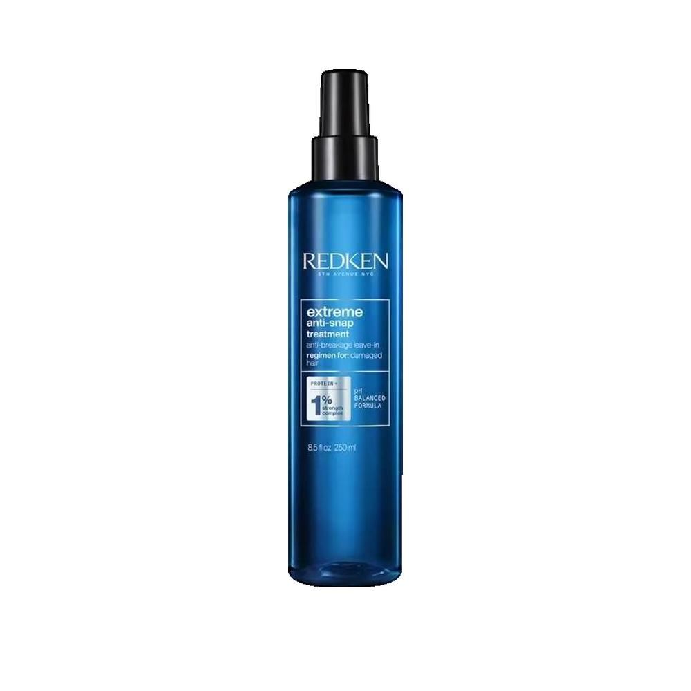 Blaue Flasche mit schwarzem Sprühkopf. Aufschrift: Redken, Extreme Anti-Snap Treatment. Für geschädigtes Haar. Mit 1% Balanced Formula.