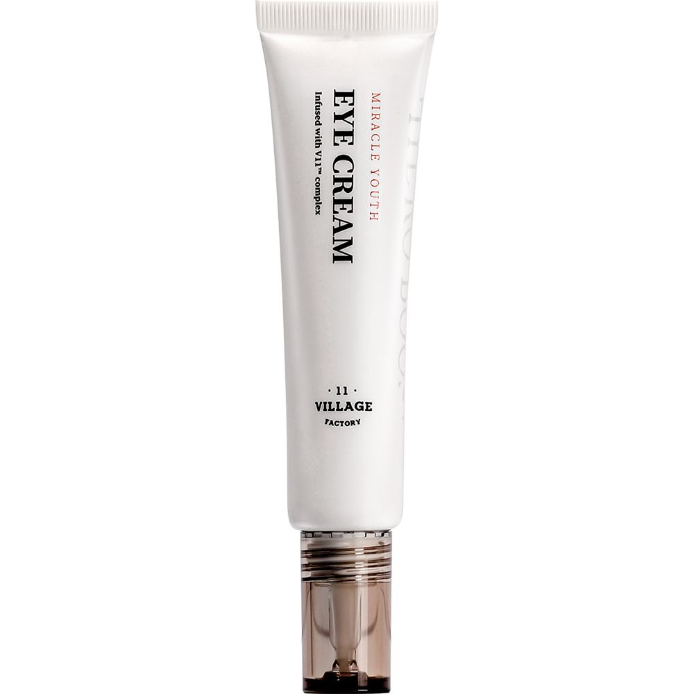 Weiße Tube mit schwarzer Schrift: EYE CREAM, MIRACLE YOUTH. Unterhalb: -11- VILLAGE FACTORY. Transparenter Verschluss.