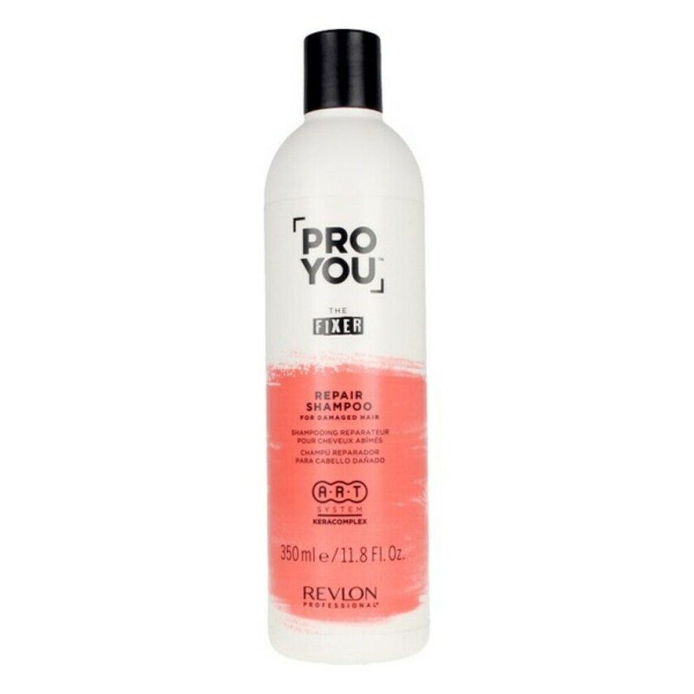 Weiße Flasche mit schwarzem Deckel. Aufschrift: PRO YOU THE FIXER REPAIR SHAMPOO. Rote Farbfläche. Revlon Professional.