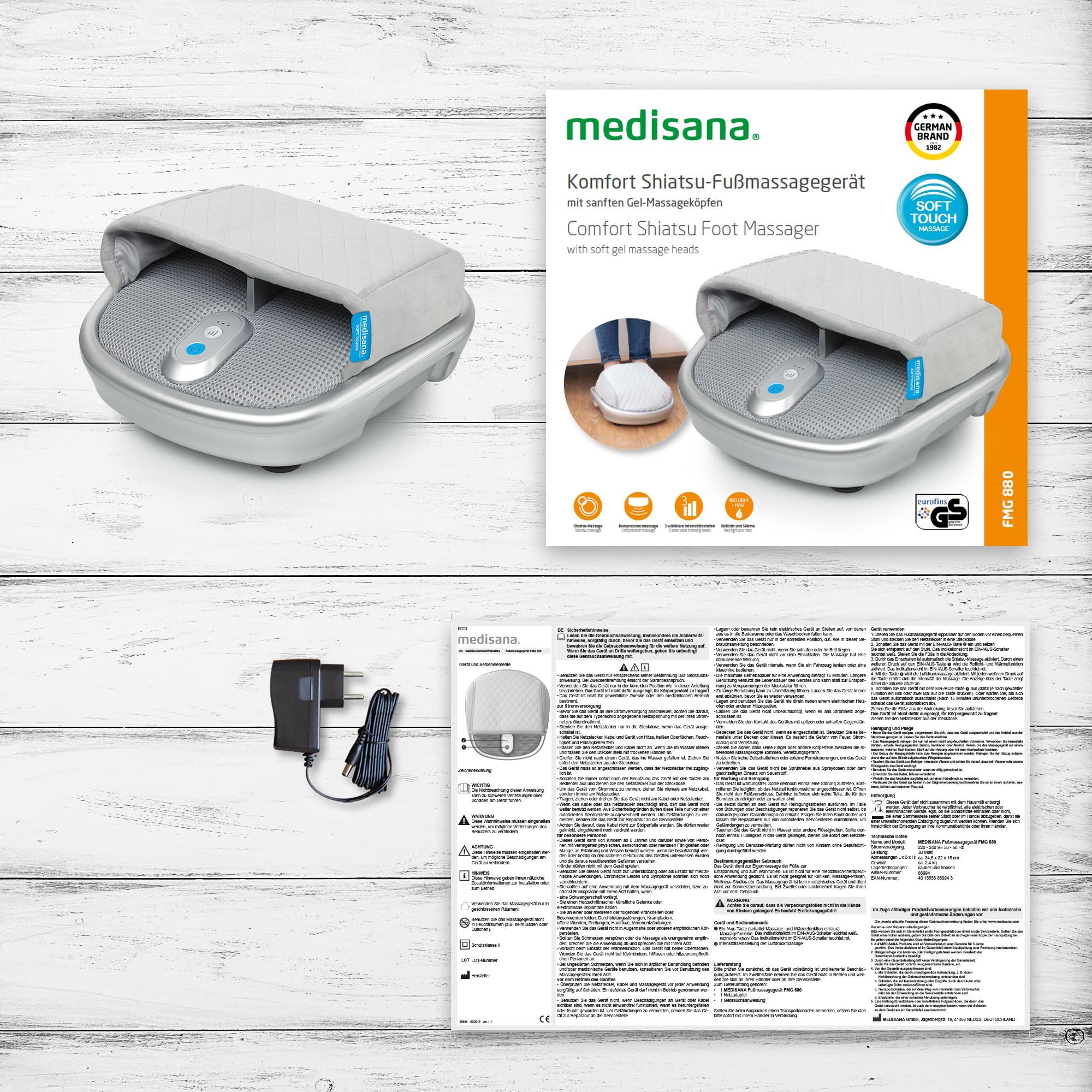 Verpackung des Shiatsu-Fußmassagegeräts. Gerät, Bedienungsanleitung, Netzteil. Medisana-Logo. Zertifizierungen.