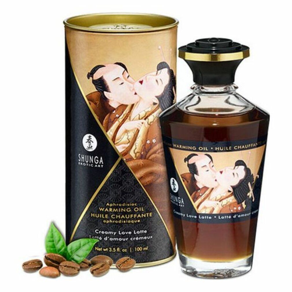Glasflasche und Dose mit Produktabbildung. Aufschrift: Shunga, Warming Oil, Creamy Love Latte. Kaffeebohnen und Blätter liegen daneben.