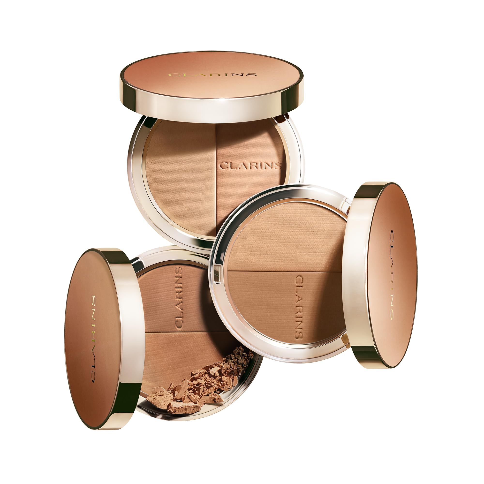 EVER BRONZE duo poudre bronzante 01. Drei runde, zweifarbige Puder-Kompakt-Make-up-Paletten. Eine Seite ist heller, die andere dunkler.