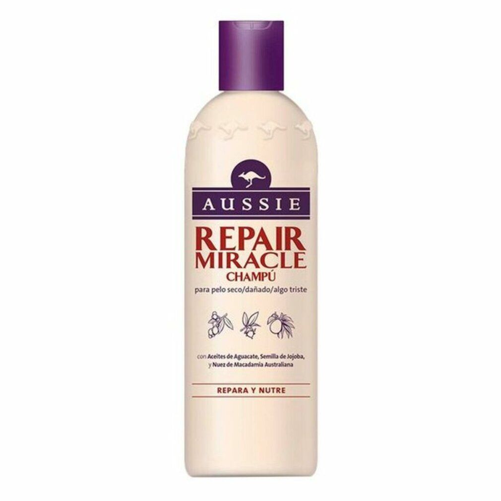 Beige Shampoo-Flasche mit lila Deckel. Aufschrift: Aussie Repair Miracle Champú. Mit Känguru-Logo.