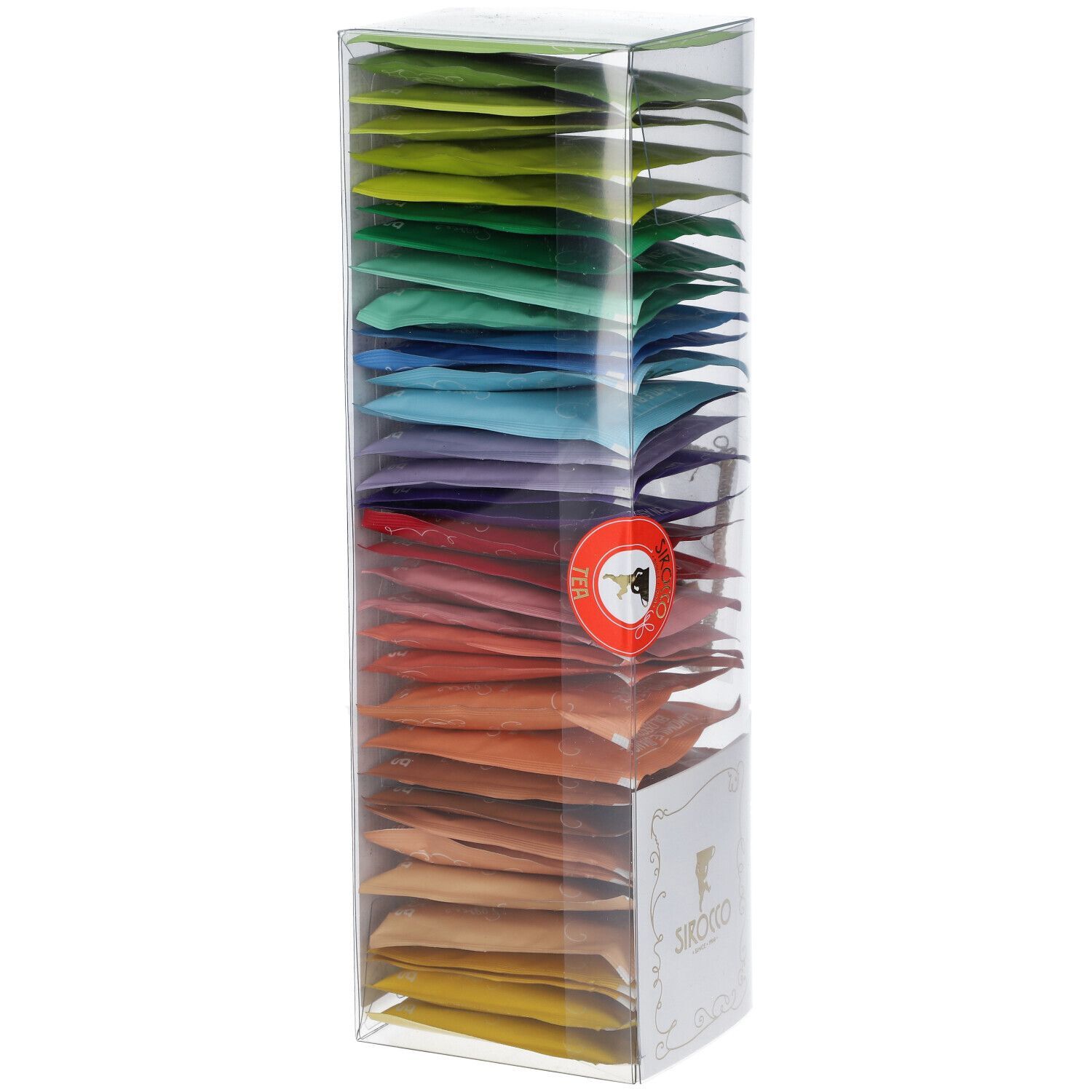 Hohe, transparente Box mit farbigen Teebeuteln. Logo auf der Vorderseite. Rotes Siegel. Teebeutel in verschiedenen Farben angeordnet.