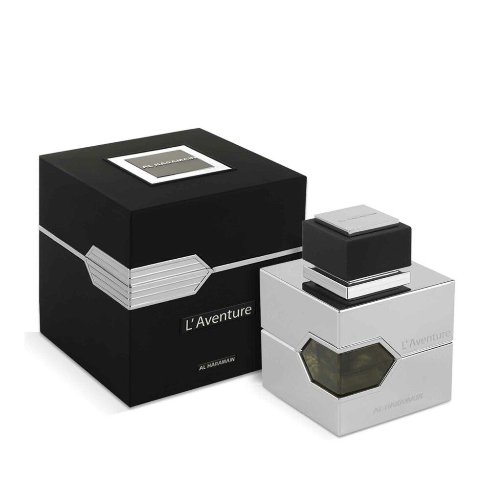 Silberfarbener Flakon mit schwarzem Deckel und schwarzer Verpackung. Schriftzug L'Aventure und Al Haramain.