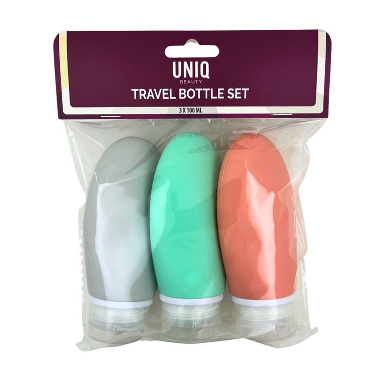 Reiseflaschenset in Plastikverpackung. Drei farbige, ovale Flaschen mit Schraubverschluss. Auf der Verpackung steht "UNIQ BEAUTY TRAVEL BOTTLE SET".