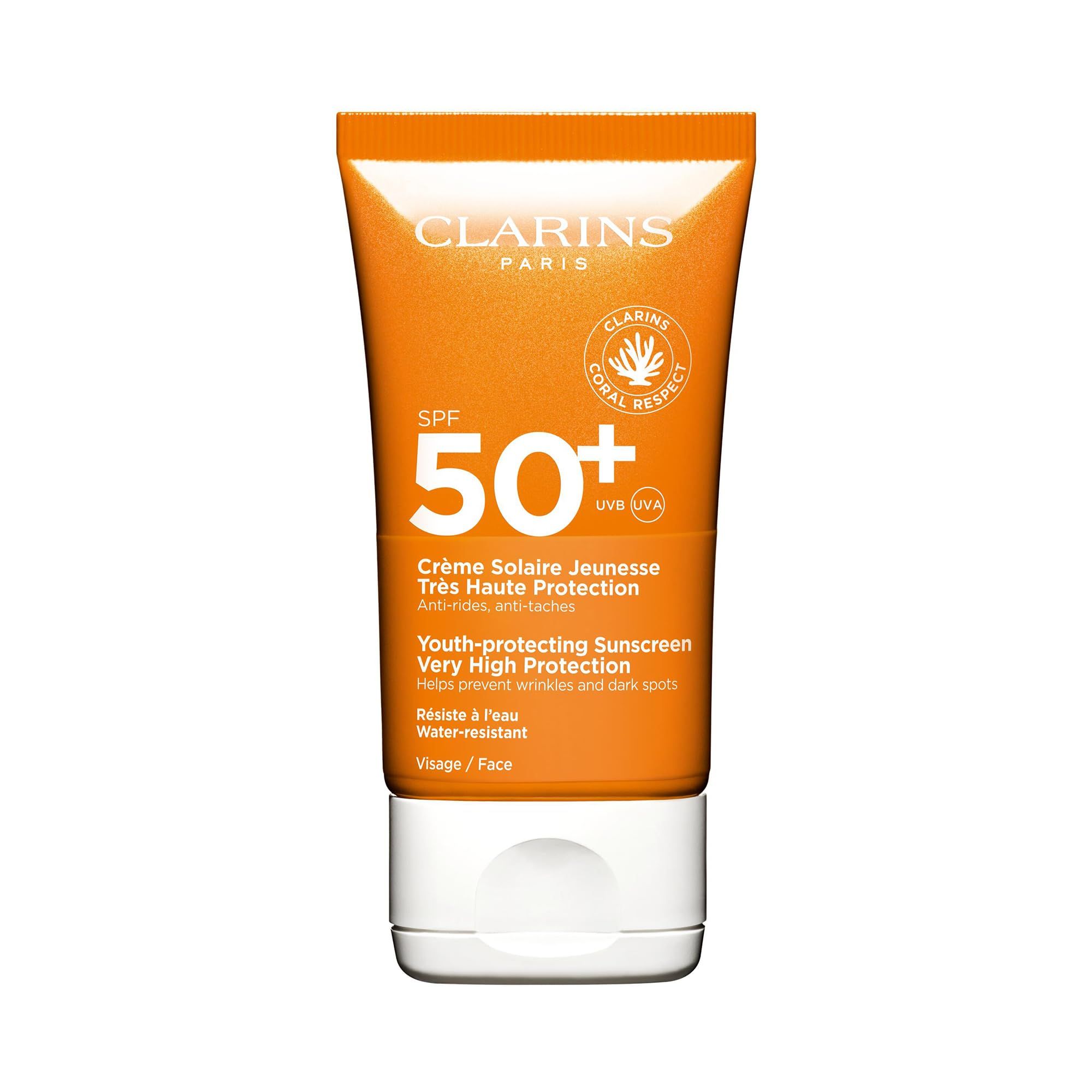 Orange Tube mit weißem Deckel. Text: Clarins Paris, SPF 50+, Crème Solaire Jeunesse, Très Haute Protection, Wasserfest.