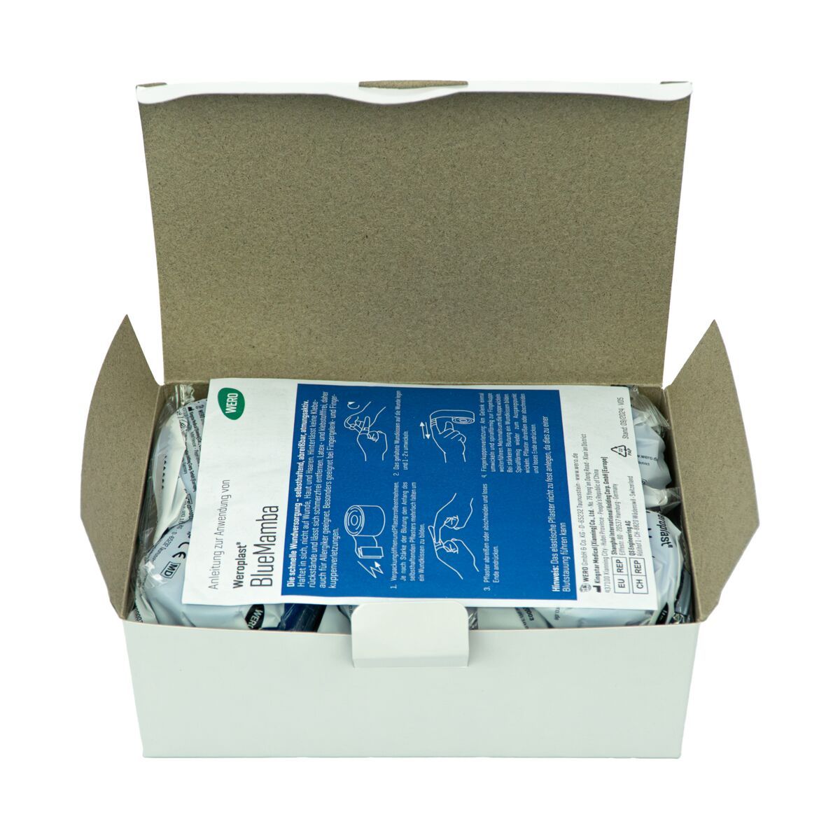 Geöffnete Schachtel mit einzeln verpackten Schnellpflastern. Bedienungsanleitung liegt obenauf. Produktname und Logo sichtbar.