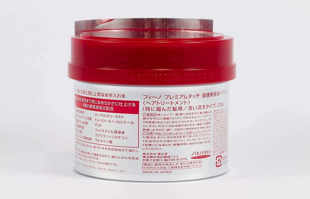 Runder Behälter mit rotem Deckel. Rückseite mit japanischer Schrift und Shiseido-Logo.