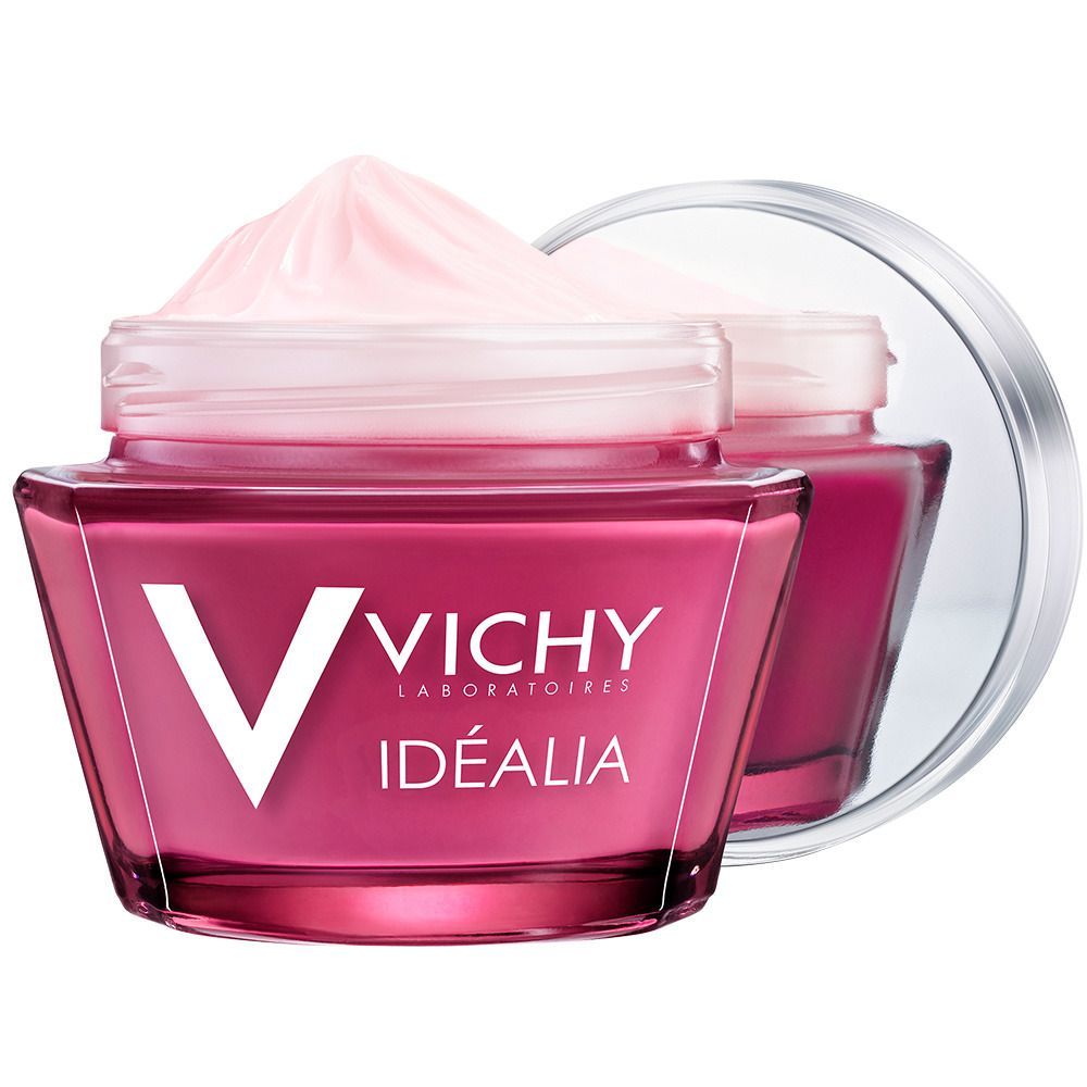 Glasbehälter mit rosa Creme und Spiegel. VICHY-Logo und Idéalia-Schriftzug. Rosa Creme im Glas, Spiegel im Hintergrund.