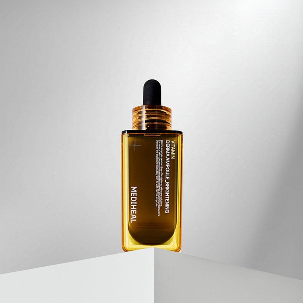 Braune, rechteckige Flasche mit gelbem Rand und schwarzem Tropfer. Aufschrift: Vitamin Derma Ampoule Brightening, MEDIHEAL.