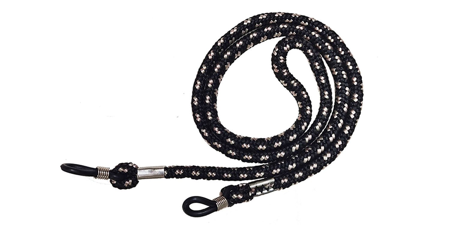 Brillenband, schwarz-weiß gemustert. Mit Schlaufen zur Befestigung an Brillenbügeln. Metallverbindungen.