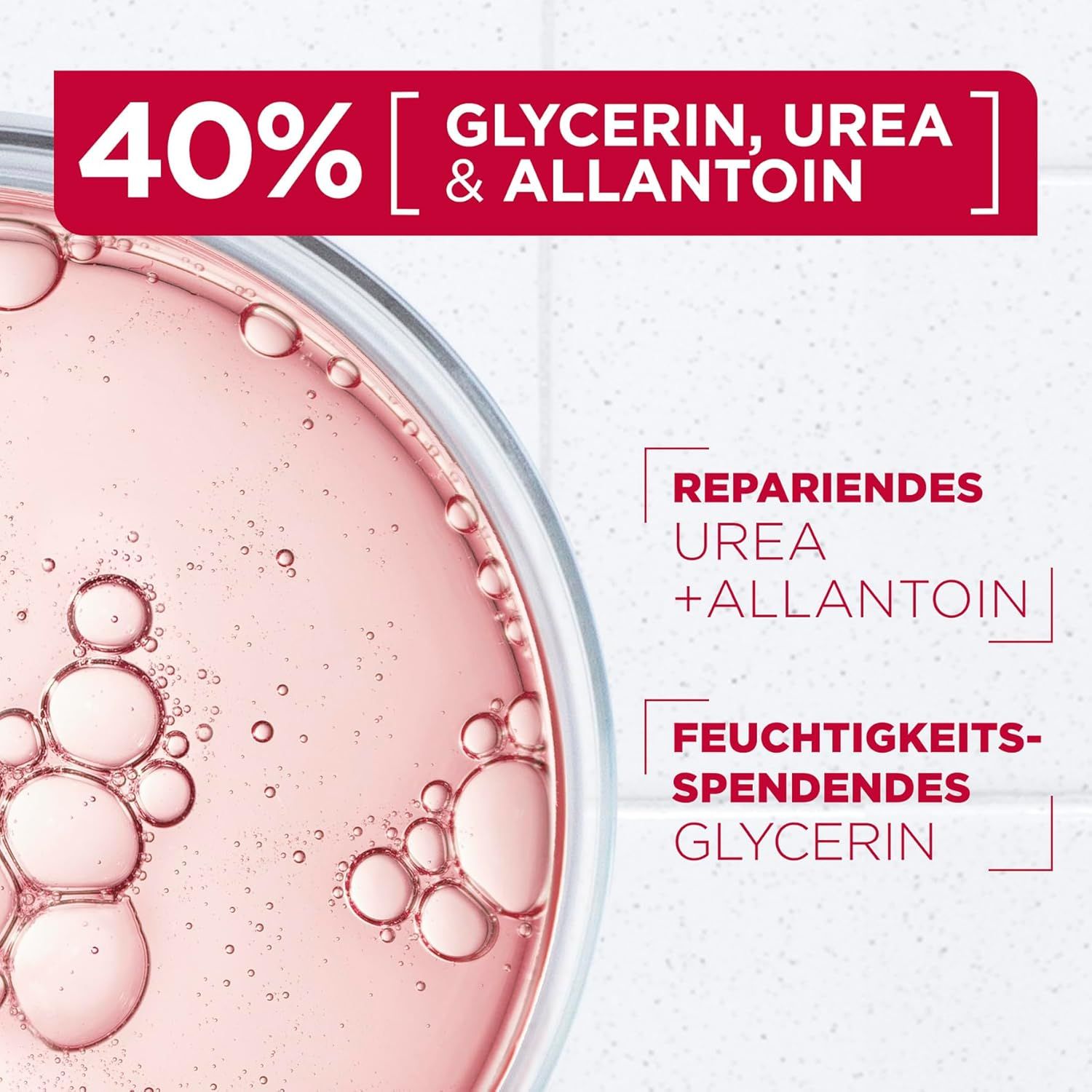 Nahaufnahme einer Flüssigkeit. Text: 40% Glycerin, Urea & Allantoin. Reparierendes Urea + Allantoin. Feuchtigkeitsspendendes Glycerin.