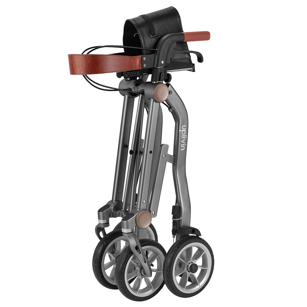 Rollator, zusammengeklappt. Grauer Rahmen, braune Griffe, schwarze Sitzfläche. Räder mit silbernen Felgen. Aufschrift "Uplivin".
