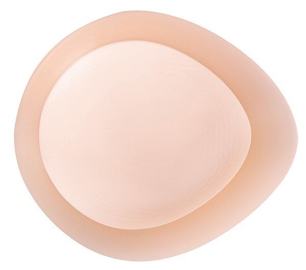 Ovale Brustprothese mit konkavem Design. Hautfarbenes Silikon.