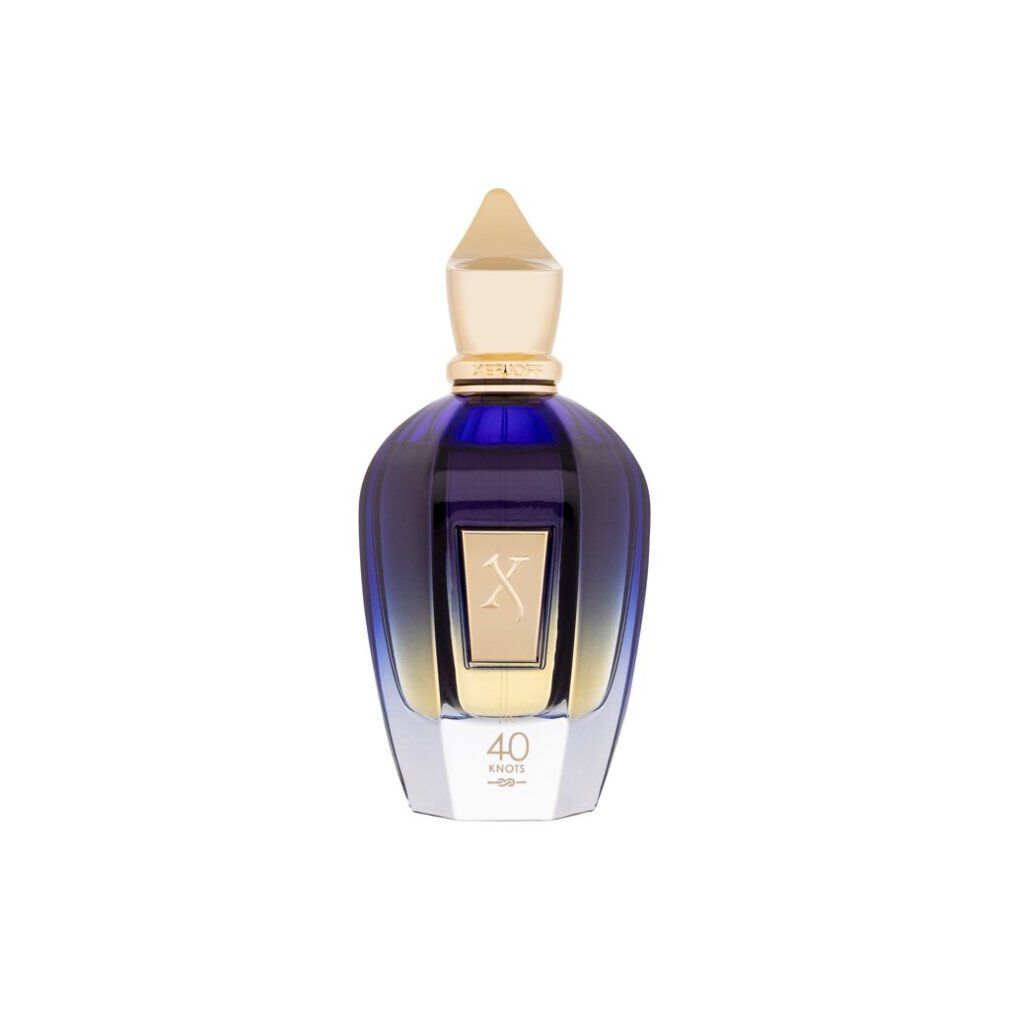 Blau-transparente Flasche mit goldfarbenem Verschluss. Goldfarbenes Etikett mit 'X' und '40 Knots'.
