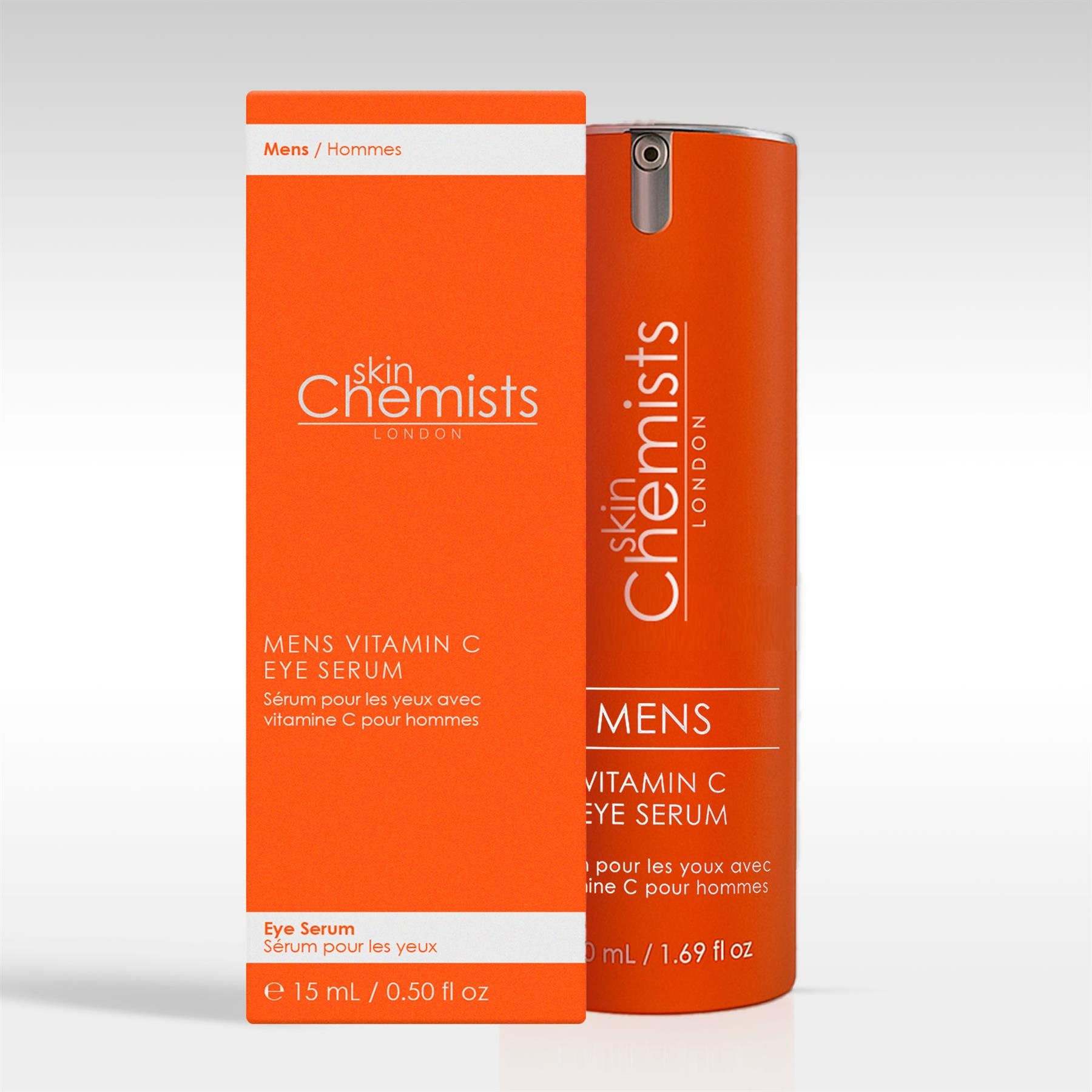 Ein orangefarbener Pumpspender 'MENS VITAMIN C EYE SERUM' neben seiner Verpackung.