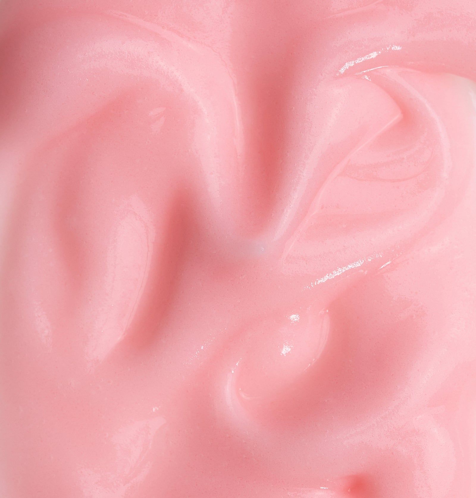 Nahaufnahme von rosa Creme. Cremetextur mit Wirbeln.