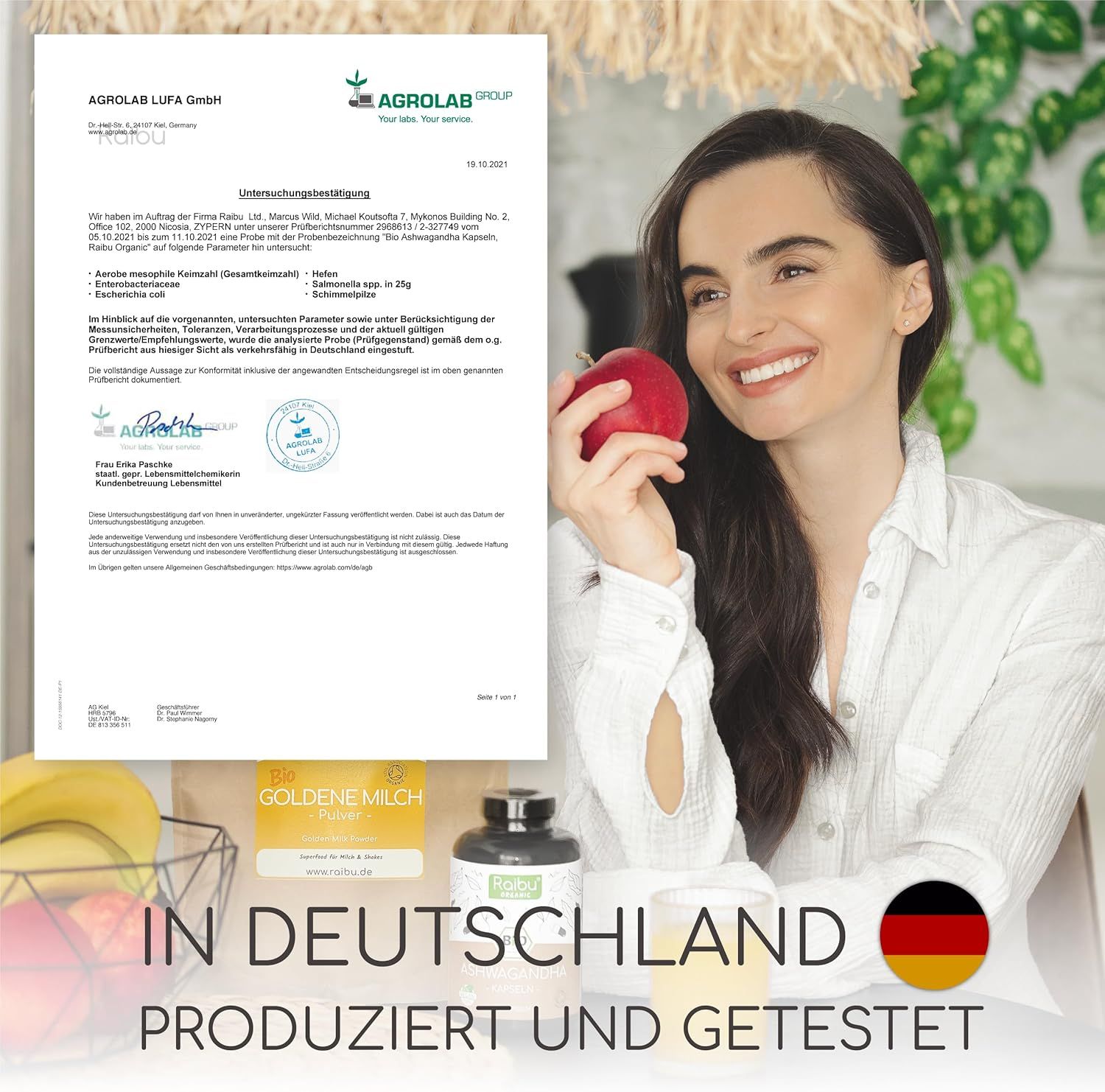 Frau mit Apfel neben Dokument und Produkten. Text: "IN DEUTSCHLAND PRODUZIERT UND GETESTET".