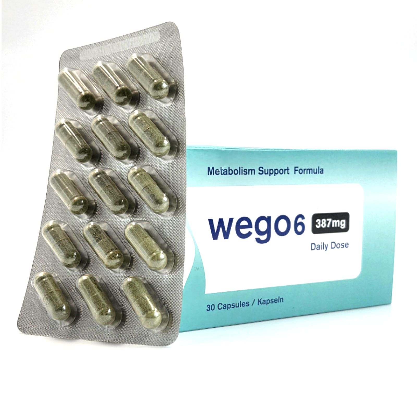 Blisterpackung mit Kapseln und Schachtel. Auf der Schachtel steht "Wego6", "387mg Daily Dose" und "30 Capsules / Kapseln".