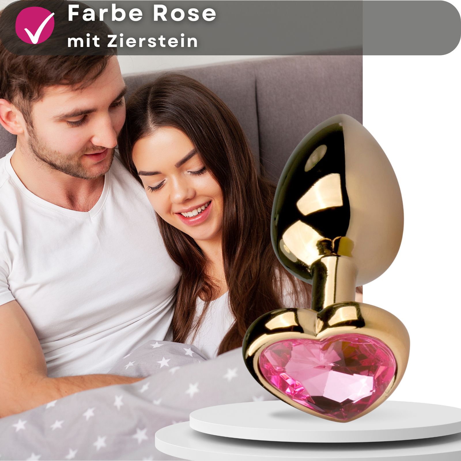 Goldfarbener Analplug mit herzförmigem Zierstein. Rosa Zierstein.