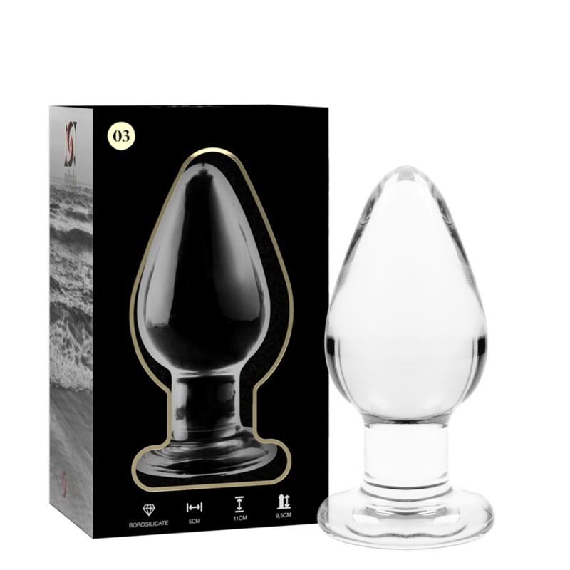 Klarer Glas-Analplug mit breiter Basis, spitz zulaufend. Verpackung mit Produktabbildung und Maßen.
