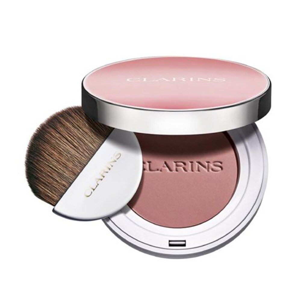 Runder Rouge-Kompaktpuder mit Pinsel. Deckel mit Schriftzug CLARINS. Puder in Rosa. Pinsel mit weißem Griff. Aufschrift CLARINS.