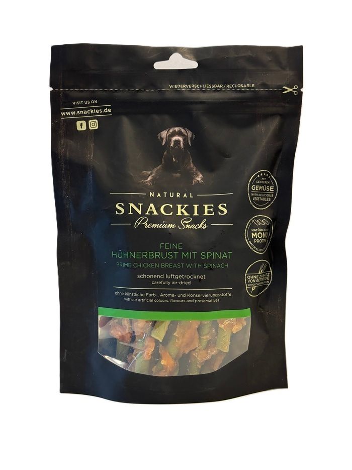 Verpackung von Snackies Feine Hühnerbrust mit Spinat. Schwarze Tüte mit Produktbild und Text. Sichtfenster mit getrocknetem Produkt.