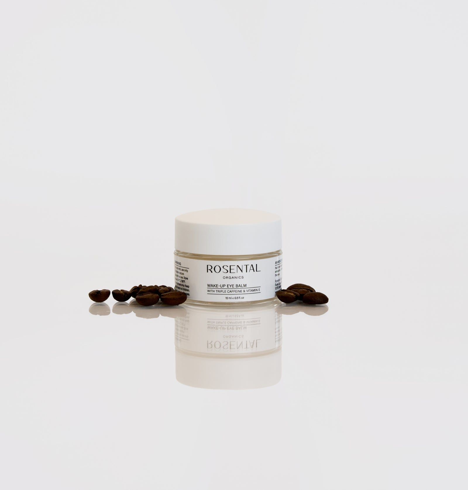 Weißes Tiegel mit Aufschrift Rosental Organics. Text: Wake-up Eye Balm, mit Triple Caffeine & Vitamin E. Kaffeebohnen daneben.