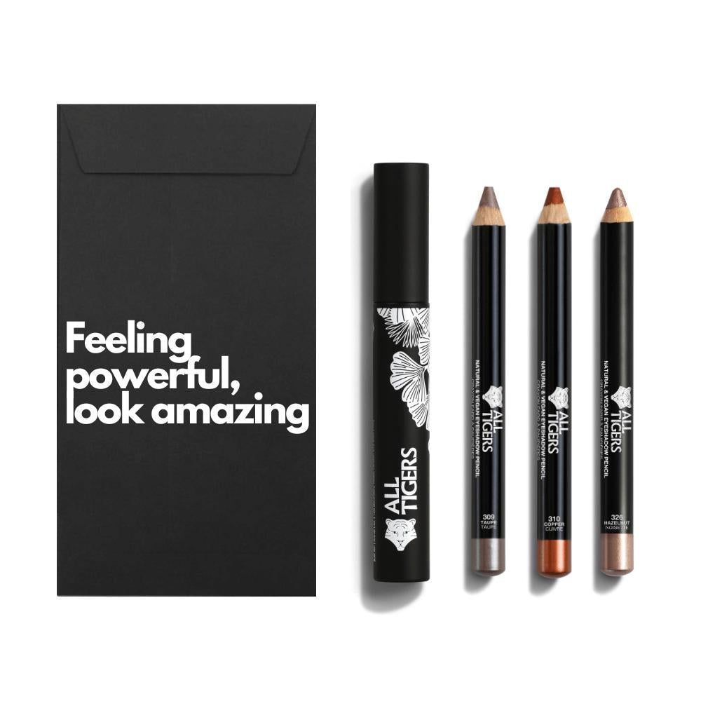 Schwarze Verpackung mit Text. Mascara und drei Augenstifte. Marke ALL TIGERS.