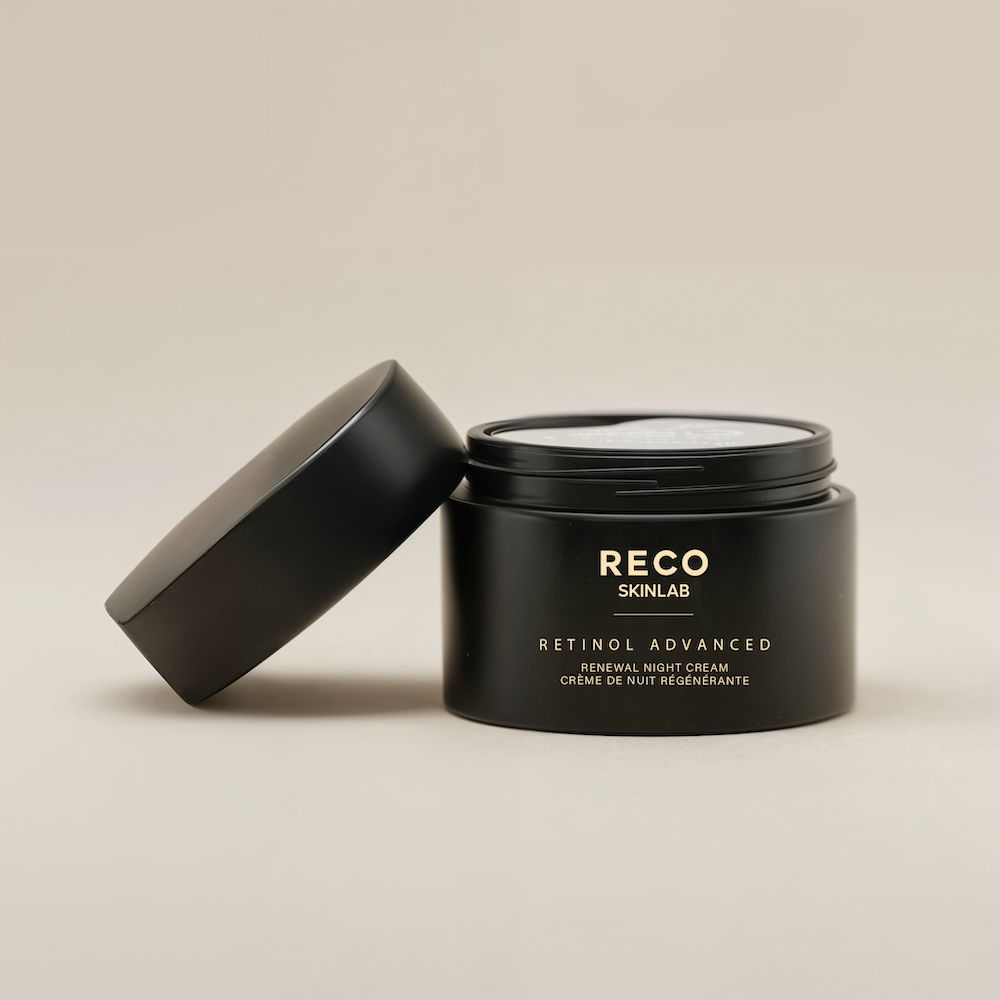 Schwarzer Tiegel mit offenem Deckel. Beschriftung: RECO SKINLAB, RETINOL ADVANCED, Renewal Night Cream. Der Deckel liegt daneben.