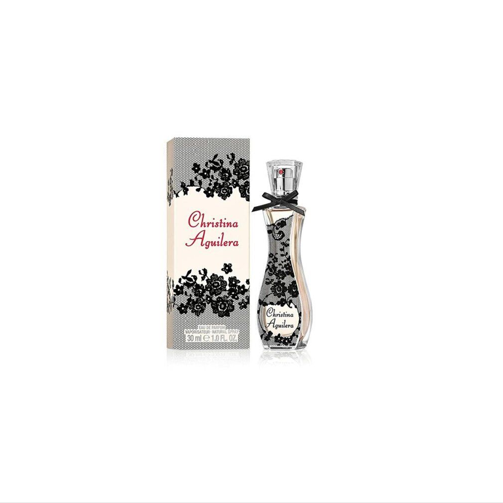 Parfümflasche und Verpackung. Flasche mit Spitzenmuster, Schleife. Verpackung mit Spitzenmuster und Aufschrift: Christina Aguilera.