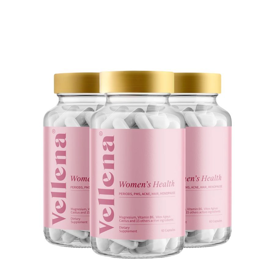 Drei Flaschen mit weißen Kapseln. Rosa Etikett mit Text: Vellena, Women's Health. Zusammensetzung, 60 Kapseln.