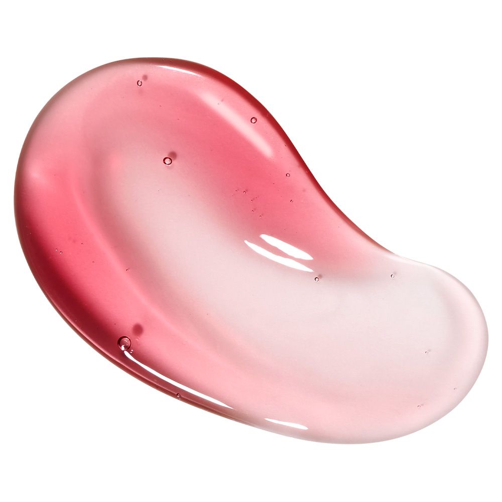 Eine rosa-rote Serum-Textur mit Luftblasen, die auf einer glatten Oberfläche verteilt ist.