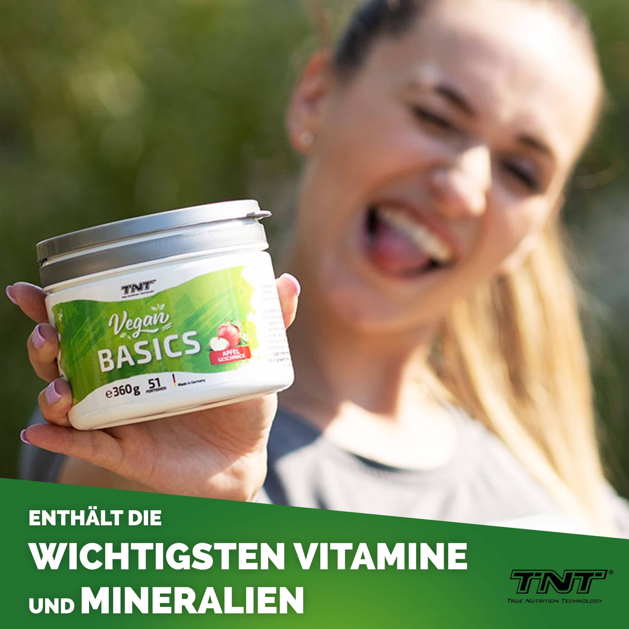 Behältnis mit Deckel. Aufschrift: Vegan Basics, Apfel Geschmack, 360g, 51 Portionen. Logo TNT. Frau mit Zunge raus.