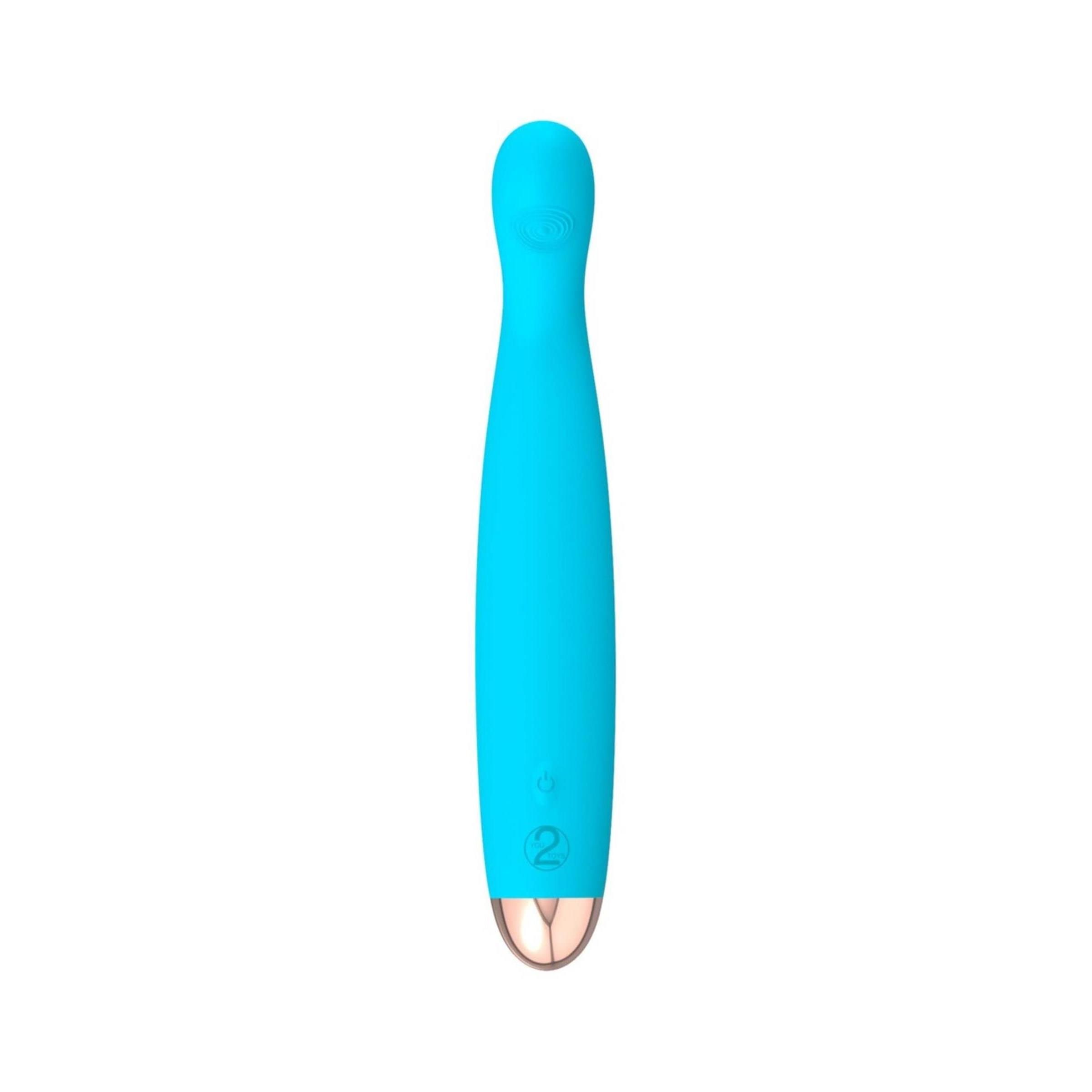 Türkisfarbener Vibrator mit gerader Form und goldfarbener Spitze. Auf weißem Hintergrund.