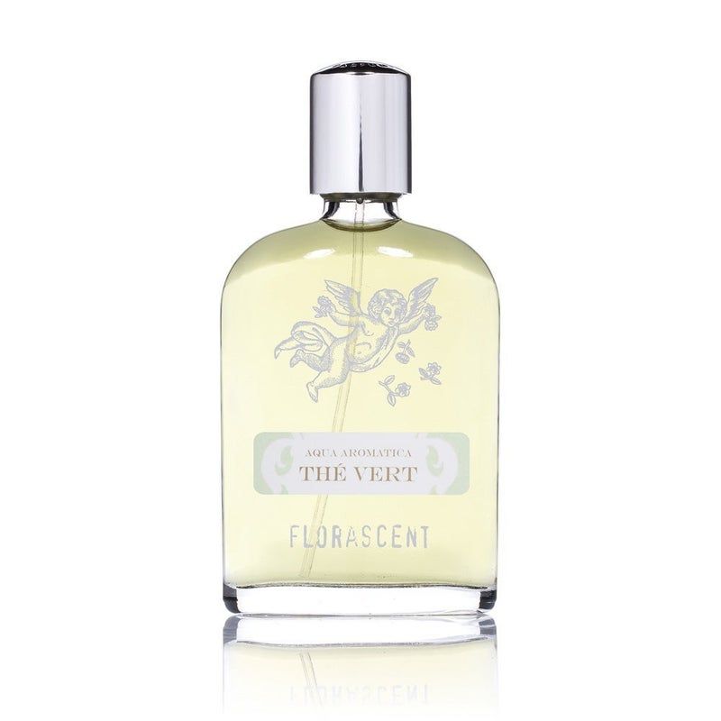 Parfümflasche mit silbernem Verschluss. Aufschrift: Aqua Aromatica, Thé Vert, Florascent. Abbildung eines Engels.