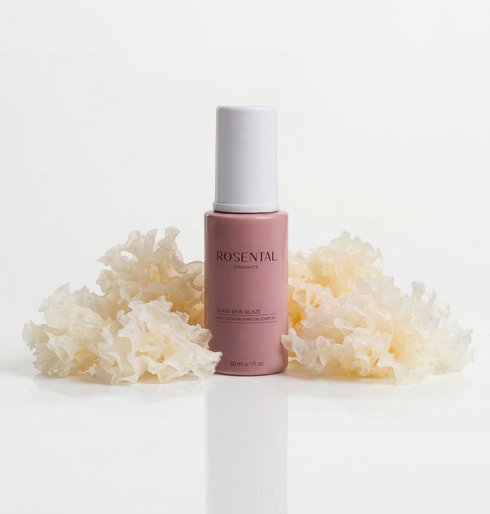 Rosa Flasche mit weißem Deckel, umgeben von Pilzen. Aufschrift: Rosental Organics, Glass Skin Glaze.